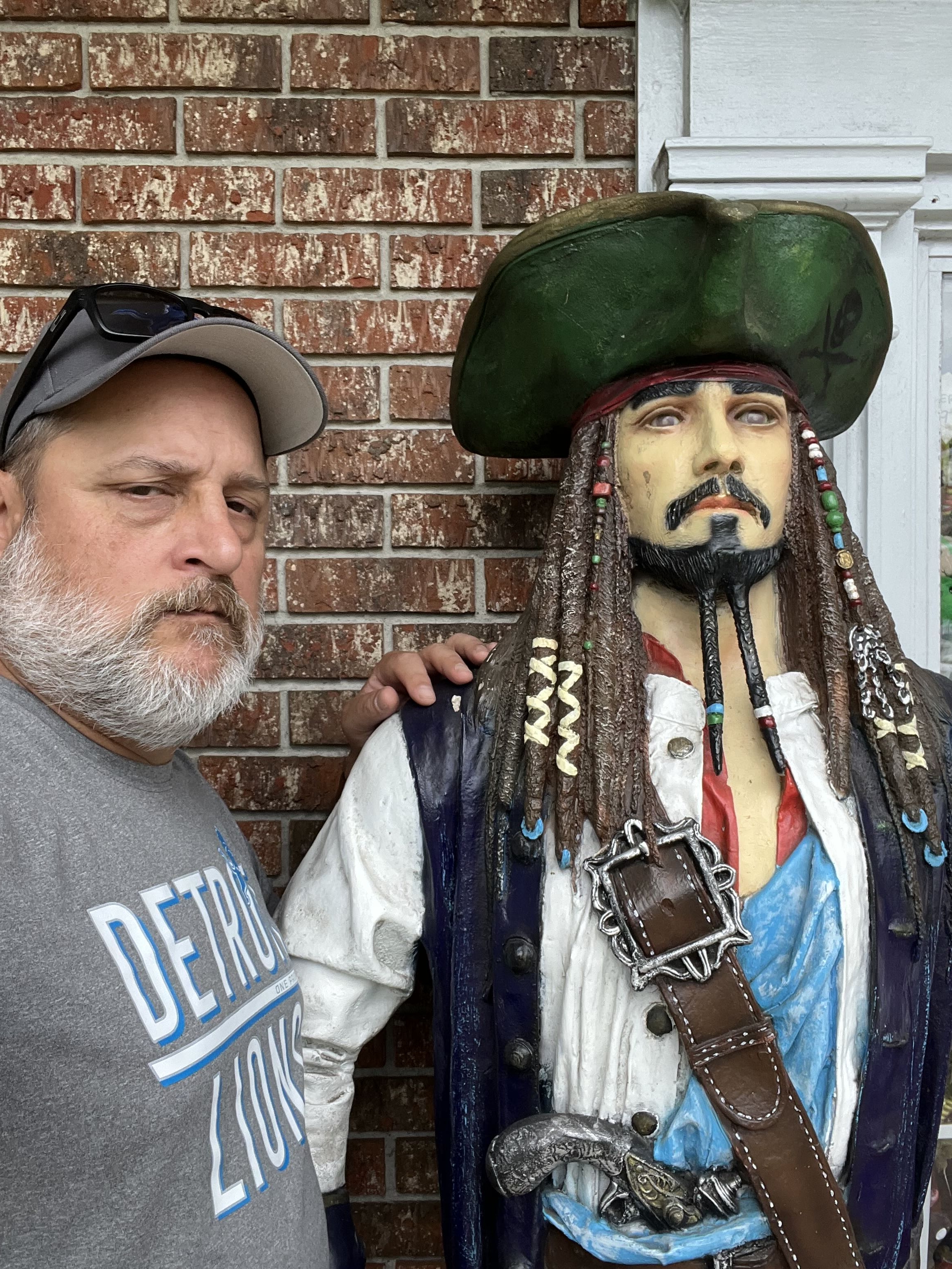My dad posing with a Captain Jack Sparrow statue.